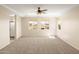 Spacious primary bedroom featuring neutral carpet, ceiling fan, and large windows at 16074 W Cortez St, Surprise, AZ 85379