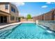 Gorgeous backyard features a sparkling pool, stone waterfall, and a basketball court at 16074 W Cortez St, Surprise, AZ 85379