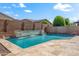 Relaxing backyard pool with baja step and stone waterfall feature at 16074 W Cortez St, Surprise, AZ 85379