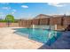 Sparkling pool features a baja shelf, stone waterfall feature, and a basketball court at 16074 W Cortez St, Surprise, AZ 85379