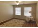 Inviting bedroom with natural light, ceiling fan, and hardwood floors with rug at 1734 E Commonwealth Cir, Chandler, AZ 85225