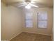 Inviting bedroom featuring a ceiling fan, neutral walls, and tile flooring at 1734 E Commonwealth Cir, Chandler, AZ 85225