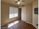 Simple bedroom with a ceiling fan, closet, and light-filled window at 1734 E Commonwealth Cir, Chandler, AZ 85225
