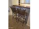 Breakfast bar featuring wicker back bar stools and neutral finishes at 1734 E Commonwealth Cir, Chandler, AZ 85225