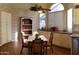 Bright and airy dining area featuring a decorative brick wall and an open shelving unit at 1734 E Commonwealth Cir, Chandler, AZ 85225