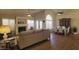 Spacious living and dining area with a fireplace, hardwood floors, and large windows at 1734 E Commonwealth Cir, Chandler, AZ 85225