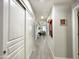 Hallway with wood-look tile, white doors and natural light at 17850 N 68Th St # 2160, Phoenix, AZ 85054