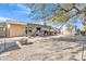 Expansive backyard with a covered patio, fire pit, and a storage shed offers ample space for outdoor activities at 19061 N 5Th Ave, Phoenix, AZ 85027