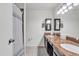 Bathroom featuring double sink vanity with granite countertop, a decorative mirror and tiled floor at 19061 N 5Th Ave, Phoenix, AZ 85027