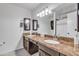 Bathroom featuring double sink vanity with granite countertop and a well-lit mirror at 19061 N 5Th Ave, Phoenix, AZ 85027