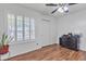 Bright bedroom featuring hardwood floors, neutral paint, shuttered windows, and ample closet space at 19061 N 5Th Ave, Phoenix, AZ 85027