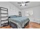 Cozy bedroom featuring wood floors, vaulted ceiling with ceiling fan and 'Love You More' wall art at 19061 N 5Th Ave, Phoenix, AZ 85027