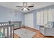 Bedroom featuring hardwood floors, a neutral gray color scheme, ample closet space, and a cozy armchair at 19061 N 5Th Ave, Phoenix, AZ 85027