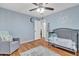 Bedroom featuring hardwood floors, a neutral gray color scheme, ample closet space, and a cozy armchair at 19061 N 5Th Ave, Phoenix, AZ 85027