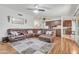 Spacious living room featuring a large sectional sofa, wood floors, and access to the kitchen at 19061 N 5Th Ave, Phoenix, AZ 85027