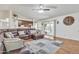 Bright living room with a comfortable sectional, wood flooring, and sliding door to the backyard at 19061 N 5Th Ave, Phoenix, AZ 85027