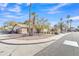 Neighborhood street showcasing well-kept homes with desert landscaping and mature palm trees at 19061 N 5Th Ave, Phoenix, AZ 85027