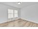 This bedroom features new flooring, a ceiling light, and two windows overlooking the backyard at 197 E Douglas Ave, Coolidge, AZ 85128