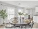 Cozy dining area with seating for four, a large plant, and lots of natural light from the window at 197 E Douglas Ave, Coolidge, AZ 85128