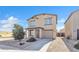 Welcoming two-story home featuring a cozy front porch, two-car garage, and xeriscaped front yard at 197 E Douglas Ave, Coolidge, AZ 85128