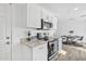 Modern kitchen with stainless steel appliances, granite countertops, and white cabinets at 197 E Douglas Ave, Coolidge, AZ 85128