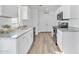 Bright kitchen with white cabinets, granite countertops, and stainless steel appliances, combining style and functionality at 197 E Douglas Ave, Coolidge, AZ 85128