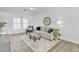 Comfortable living area with a neutral color palette, hardwood floors, and a large window for natural light at 197 E Douglas Ave, Coolidge, AZ 85128