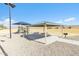 Community playground with covered picnic and barbecue area, plus green space under a clear blue sky at 197 E Douglas Ave, Coolidge, AZ 85128