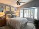 Serene main bedroom with a vaulted ceiling, a bay window with shutters, and cozy decor at 20315 N 82Nd Ln, Peoria, AZ 85382