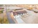 This elevated view shows the house, large driveway, and the full horse arena to the rear of the home at 20438 W Carver Rd, Buckeye, AZ 85326