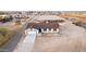 An aerial view of the property showcases the house, its surrounding land, and the horse facilities at 20438 W Carver Rd, Buckeye, AZ 85326