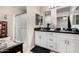 Well-lit bathroom featuring dual sinks, vanity, and shower with glass door at 20438 W Carver Rd, Buckeye, AZ 85326