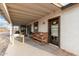 Covered patio featuring rustic wooden furniture and views of horse property, ideal for relaxing outdoors at 20438 W Carver Rd, Buckeye, AZ 85326