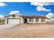 Single-story home featuring a two-car garage and rustic wood fence under a blue and cloudy sky at 20438 W Carver Rd, Buckeye, AZ 85326