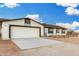 Single-story home featuring a two-car garage and a well-maintained concrete driveway, perfect for easy parking at 20438 W Carver Rd, Buckeye, AZ 85326