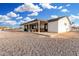 Rear exterior view showcases a large covered patio offering the perfect place for outdoor entertainment and relaxation at 20438 W Carver Rd, Buckeye, AZ 85326