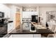 Kitchen island with granite countertop and seating, complemented by modern appliances and stylish cabinetry at 20438 W Carver Rd, Buckeye, AZ 85326