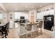 Bright kitchen with white cabinets, a center island, and black appliances, seamlessly connecting to the dining area at 20438 W Carver Rd, Buckeye, AZ 85326