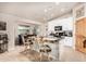 Stylish kitchen with an island featuring seating, granite counters, and white cabinetry, designed for modern living at 20438 W Carver Rd, Buckeye, AZ 85326