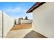 View of the home's backyard with a privacy wall, a storage shed, and low maintenance landscaping at 2053 W Pecan Rd, Phoenix, AZ 85041