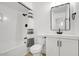 Bright bathroom featuring a shower/tub combination, a toilet, and a modern vanity with a framed mirror at 2053 W Pecan Rd, Phoenix, AZ 85041