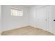 Bedroom with light wood floors, closet and a window at 2053 W Pecan Rd, Phoenix, AZ 85041