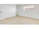 Bright bedroom featuring light wood floors, a large window, and a double door closet at 2053 W Pecan Rd, Phoenix, AZ 85041