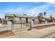 Charming home with a white wall, black wrought iron fence, and manicured front yard at 2053 W Pecan Rd, Phoenix, AZ 85041