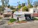 Aerial view of single-story home featuring a two-car garage, carport, gated front yard and desert landscaping at 2140 E Rosarita Dr, Tempe, AZ 85281