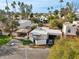 Wide aerial shot of home featuring a two-car garage, carport, gated front yard and desert landscaping at 2140 E Rosarita Dr, Tempe, AZ 85281