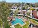 Aerial view of community pool with clear blue water, surrounded by lush landscaping and red tile rooftops at 2140 E Rosarita Dr, Tempe, AZ 85281