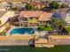 Aerial view of a waterfront home with a large pool, patio, private dock, and well-kept backyard at 21666 N 53Rd Dr, Glendale, AZ 85308