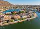 Stunning aerial view of waterfront homes with pools and boat docks in a picturesque community near mountains at 21666 N 53Rd Dr, Glendale, AZ 85308