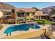 Backyard view of the home with a swimming pool, patio area, and waterfront dock at 21666 N 53Rd Dr, Glendale, AZ 85308